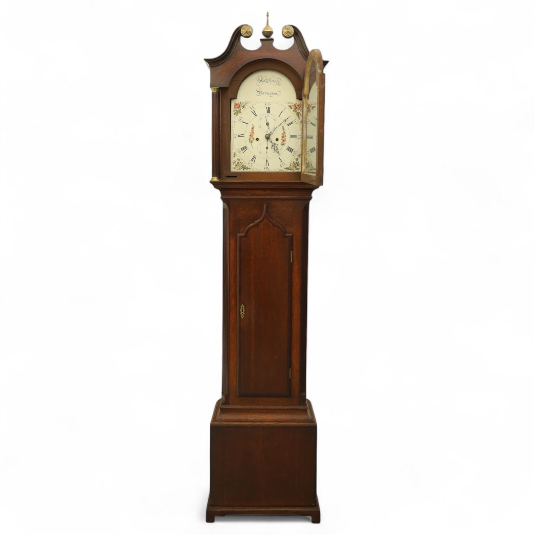 Thomas Hawkswell of Brompton (Nr Pickering-Yorks), 8-day oak cased longcase clock with a swan necked pediment and central brass finial, break arch hood door flanked by reeded pilasters with brass capitals, trunk with canted corners and a spire topped door, square plinth raised on a shaped skirting, painted dial with floral spandrels and makers name to the arch, with Roman numerals, calendar and seconds dial and pierced steel hands, dial pinned to a twin train rack striking movement, striking the hours on a bell. With weights and pendulum.