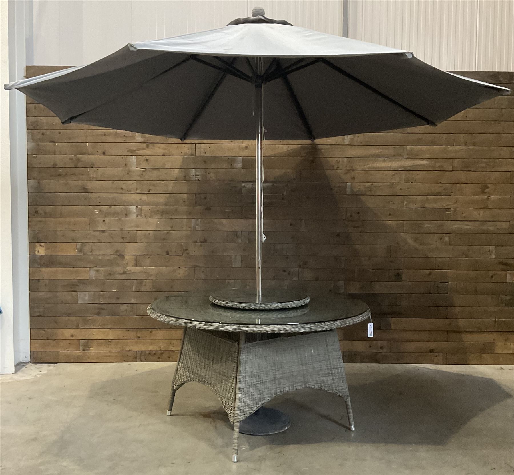 LeisureGrow circular rattan garden table, with lazy Susan, five armchairs with cushions, parasol and weighted base, with glass tops