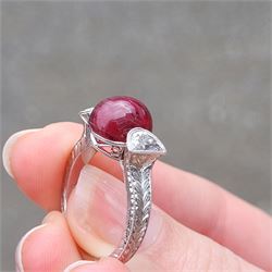18ct white gold pink tourmaline and diamond ring, single oval cabochon cut tourmaline of approx 4.75 carat, set with a half moon cut diamond either side, to engraved laurel leaf design shoulders