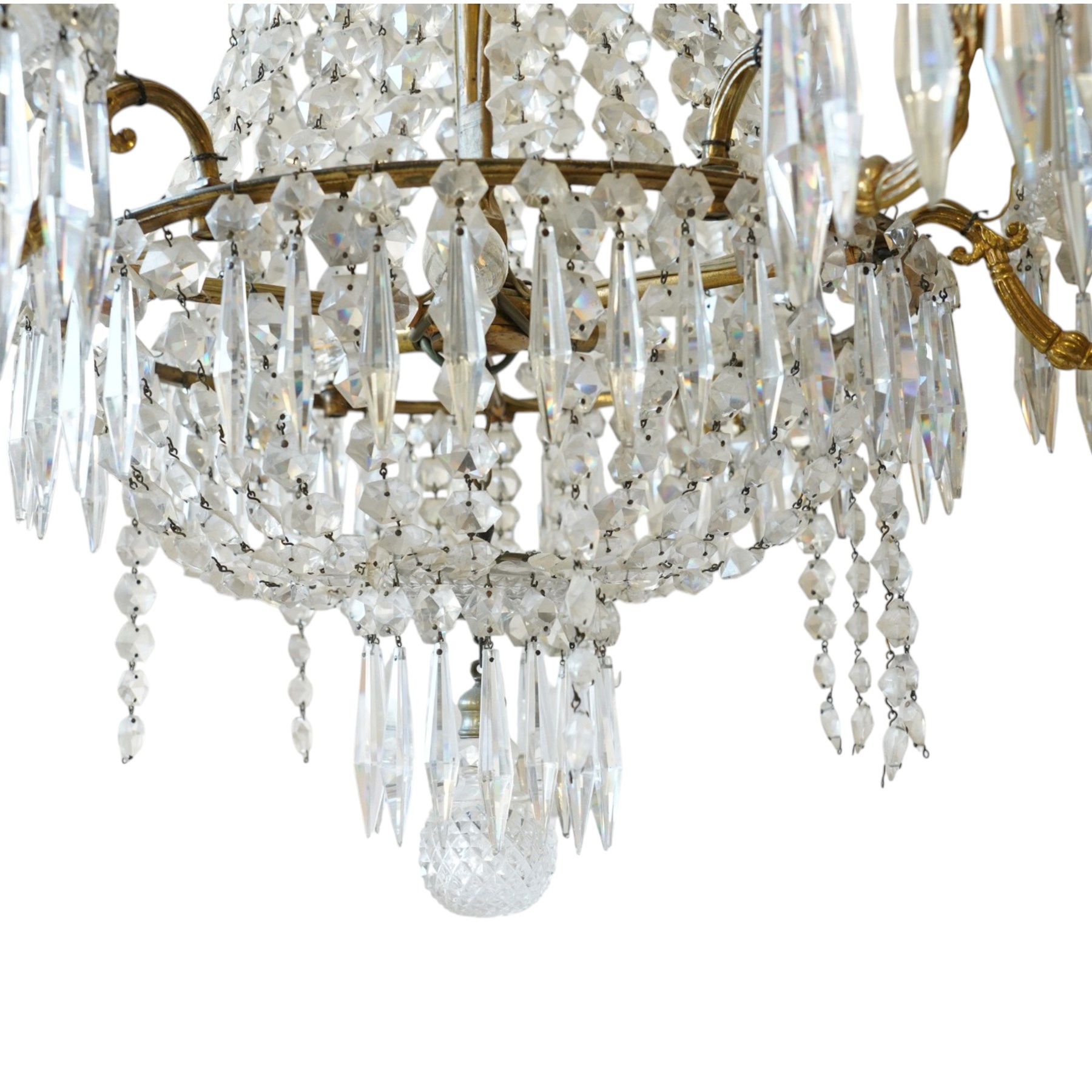 Regency Country House cut-glass and ormolu six light chandelier, the outer shaft with ormolu foliate moulding hung with octagonal and drop pendants, the impressive central shaft with cascading drops of cut-glass, the scroll branches with hob-nail cut candle holders and wax pans, with central similarly cut terminal
Provenance: property of a nobleman