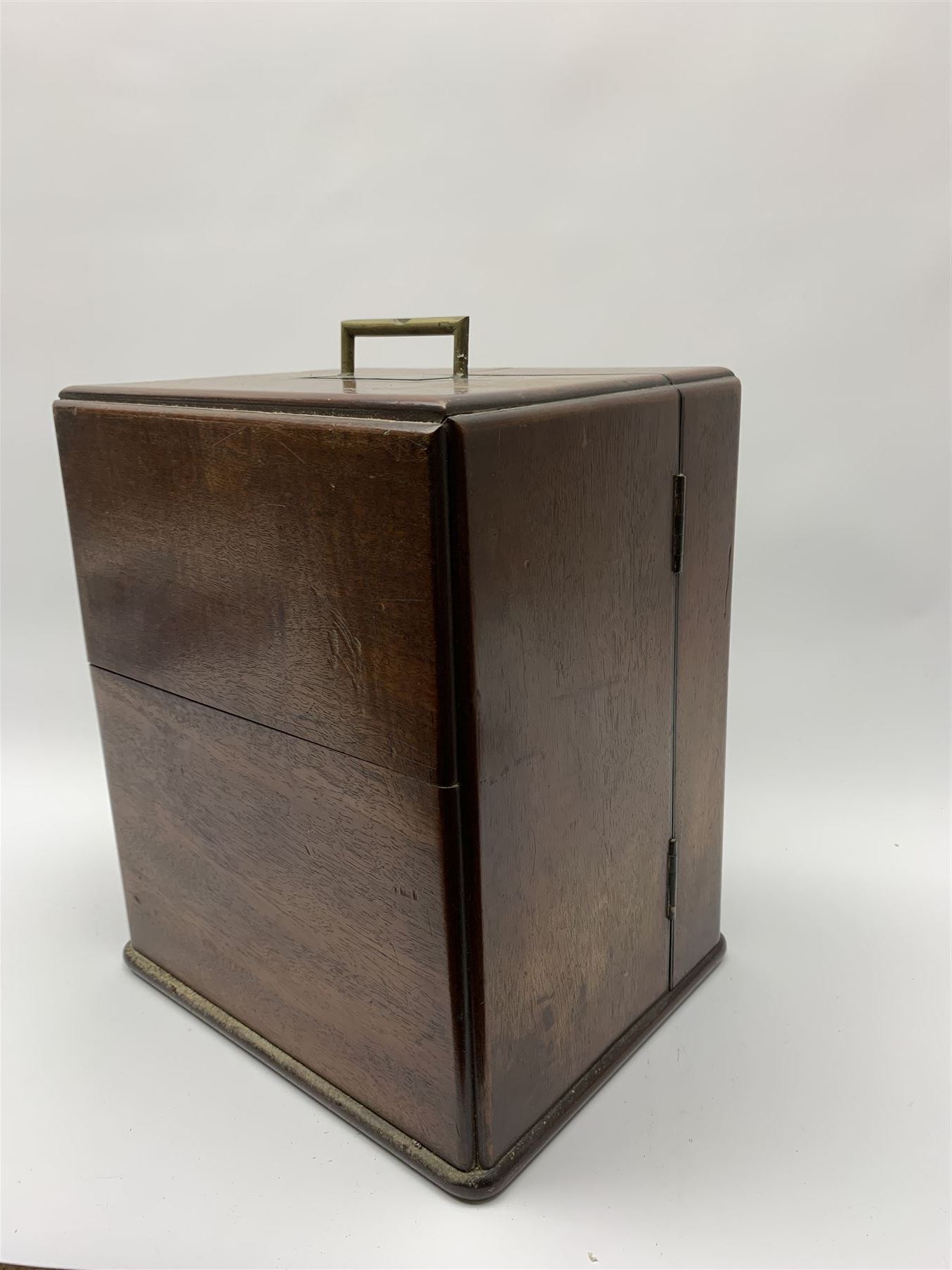 19th century mahogany travelling apothecary cabinet, with recessed brass carry handle to top, and two deep-section hinged doors to the front opening to reveal a fitted interior with clear glass bottles and two drawers, H27cm