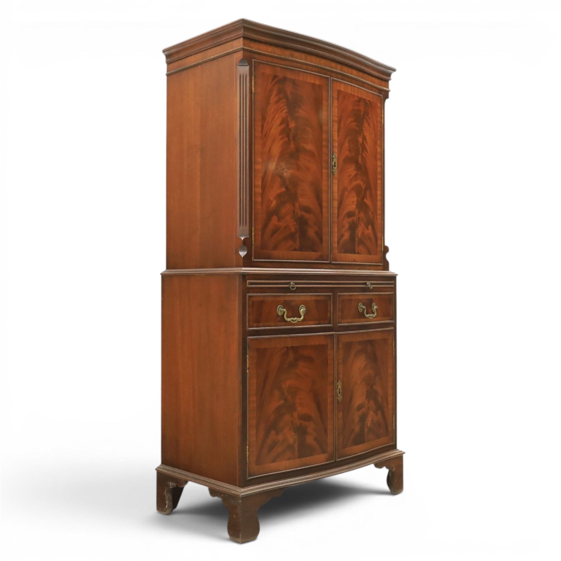 Georgian design mahogany cocktail drinks cabinet, bow fronted with mirrored and maple interior, slide out mirrored serving area, over two drawers and a cabinet below, raised on bracket feet