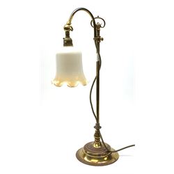 A brass rise and fall students lamp, with opaque white frilled glass shade, H55cm.