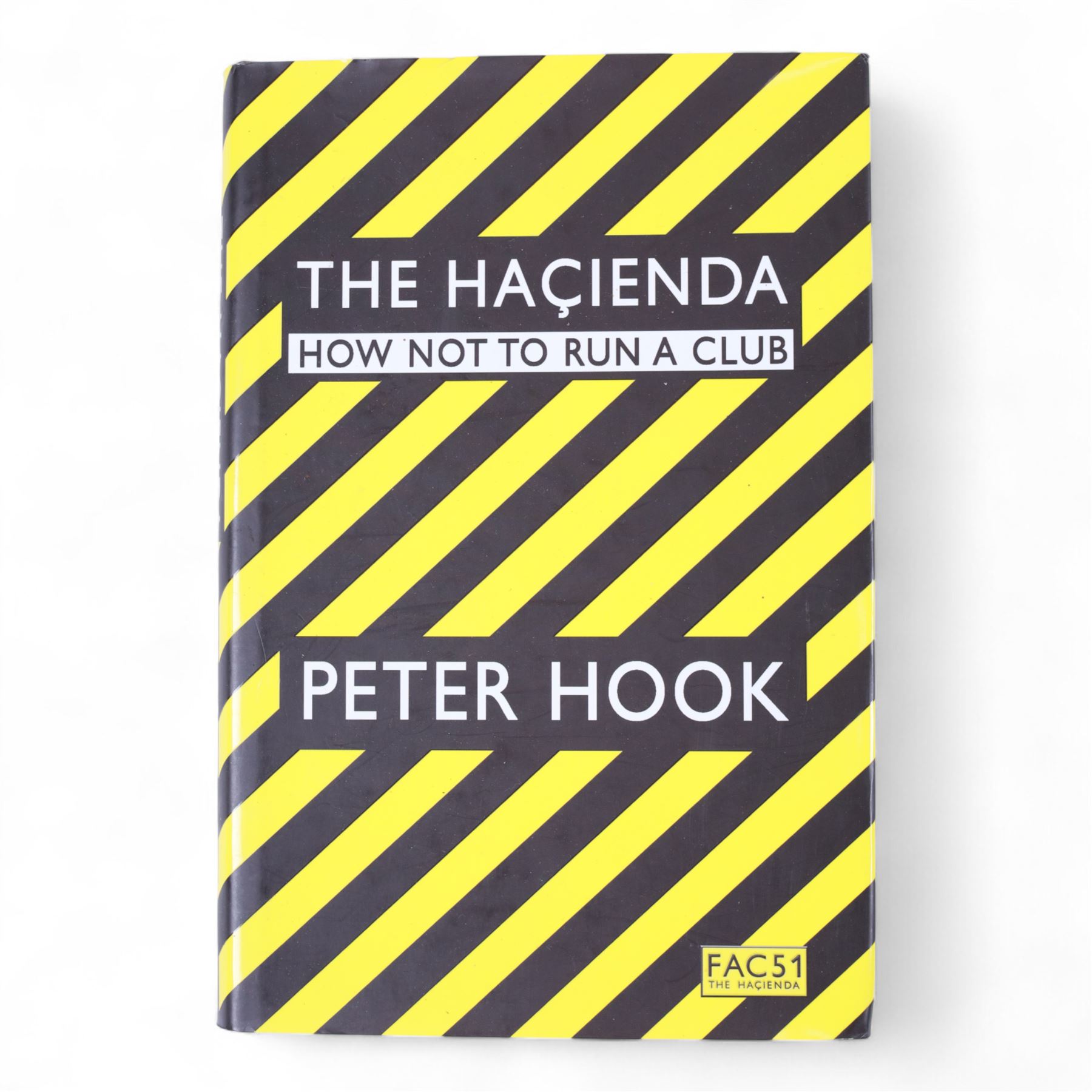 Joy Division/New Order framed album inserts and CDs, both signed by Peter Hook, together with three signed Peter Hook books 'Unknown Pleasures', 'Substance' and 'The Hacienda' and two The Hacienda t-shirts, frame H33cm