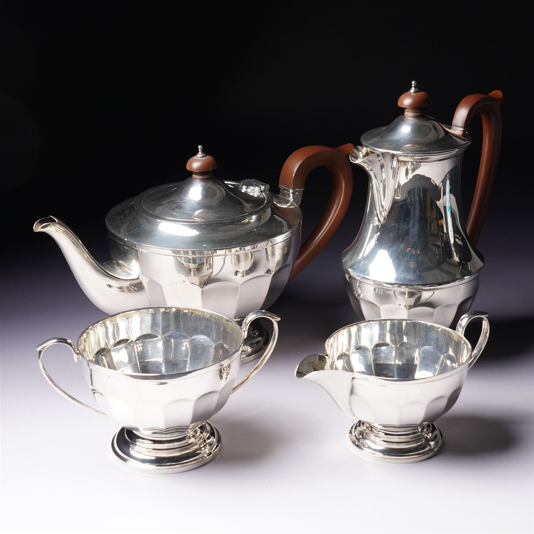 Silver three piece tea set of panelled circular form Birmingham 1929 Maker Synyer & Beddoes and a similar hot water jug Sheffield 1954 