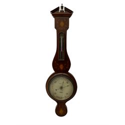 A compact Edwardian Aneroid barometer in a  Regency “Sheraton style”case, broken pediment with finial and rounded base, mahogany veneered with satinwood stringing to the edge and panels of coloured and shaded conch shell and leaf inlay enclosed within entwined leaves, with a six inch dial recording barometric air pressure from 28 to 31 inches in fifths of an inch, steel indicating hand and brass recording hand, dial inscribed “J Casartelli & Son, 43 Market Street, Manchester”, with a flat bevelled glass and brass bezel, glazed arched topped thermometer box with a spirit thermometer and silvered register recording the temperature in degrees Fahrenheit.
*J Carsatelli & Son (1896-1925) A partnership between Joseph Lewis and his son Joseph Henry. The elder Joseph died in 1900 and the son carried on the business until his death in 1925.  
