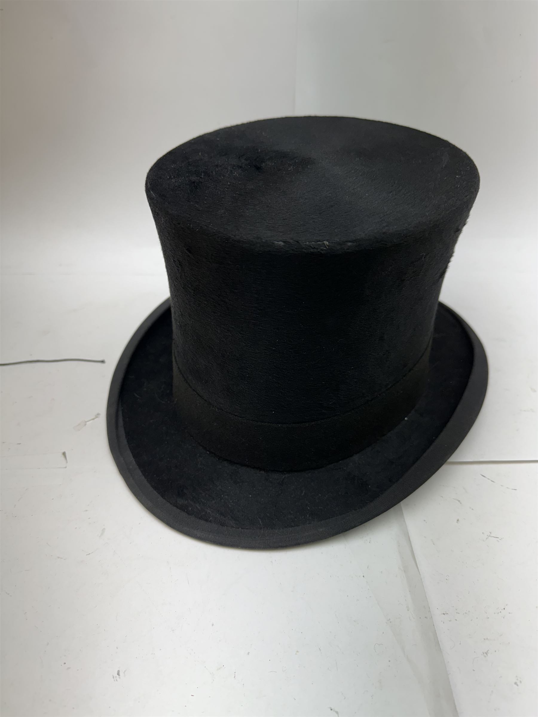 Akubra pure fur felt trilby hat, together with another trilby and two top hats, one by Woodrow and one by Dunn & Co