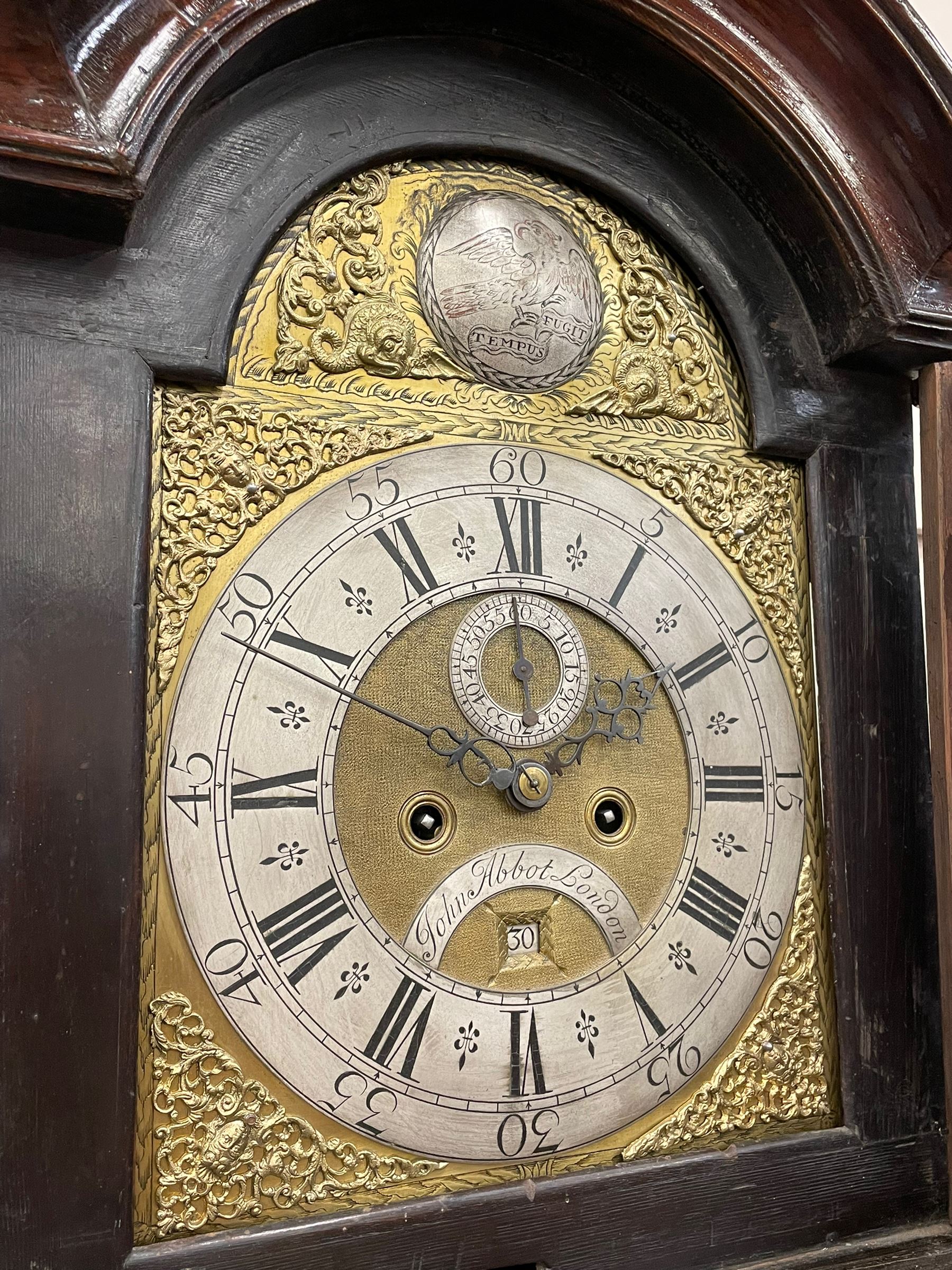 John Abbot of London – early 18th century walnut 8-day longcase clock c1740, hood with glazed side panels and tall swept pagoda pediment above a break arch hood door with attached pillars and gesso wooden capitals, long trunk door with a conforming break arch top on a rectangular plinth with applied shaped skirting, brass dial with a matted center and continuous herringbone engraving to the surround, cast spandrels, silvered chapter with Roman numerals, five minute Arabic’s, minute track and inner quarter hour track, subsidiary seconds dial and square date aperture, silvered tempus fugit boss to the break arch, dial pinned directly to a rack striking movement, striking the hours on a bell. With weights and pendulum.