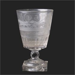 Early 19th century glass rummer, the deep bucket shaped bowl engraved with an oval roundel containing initials BC flanked by flowers of the Union, and a carriage drawn by four horses, above cut fluted and vertical cut bands, upon a short diamond cut knop stem, and square base, H15cm