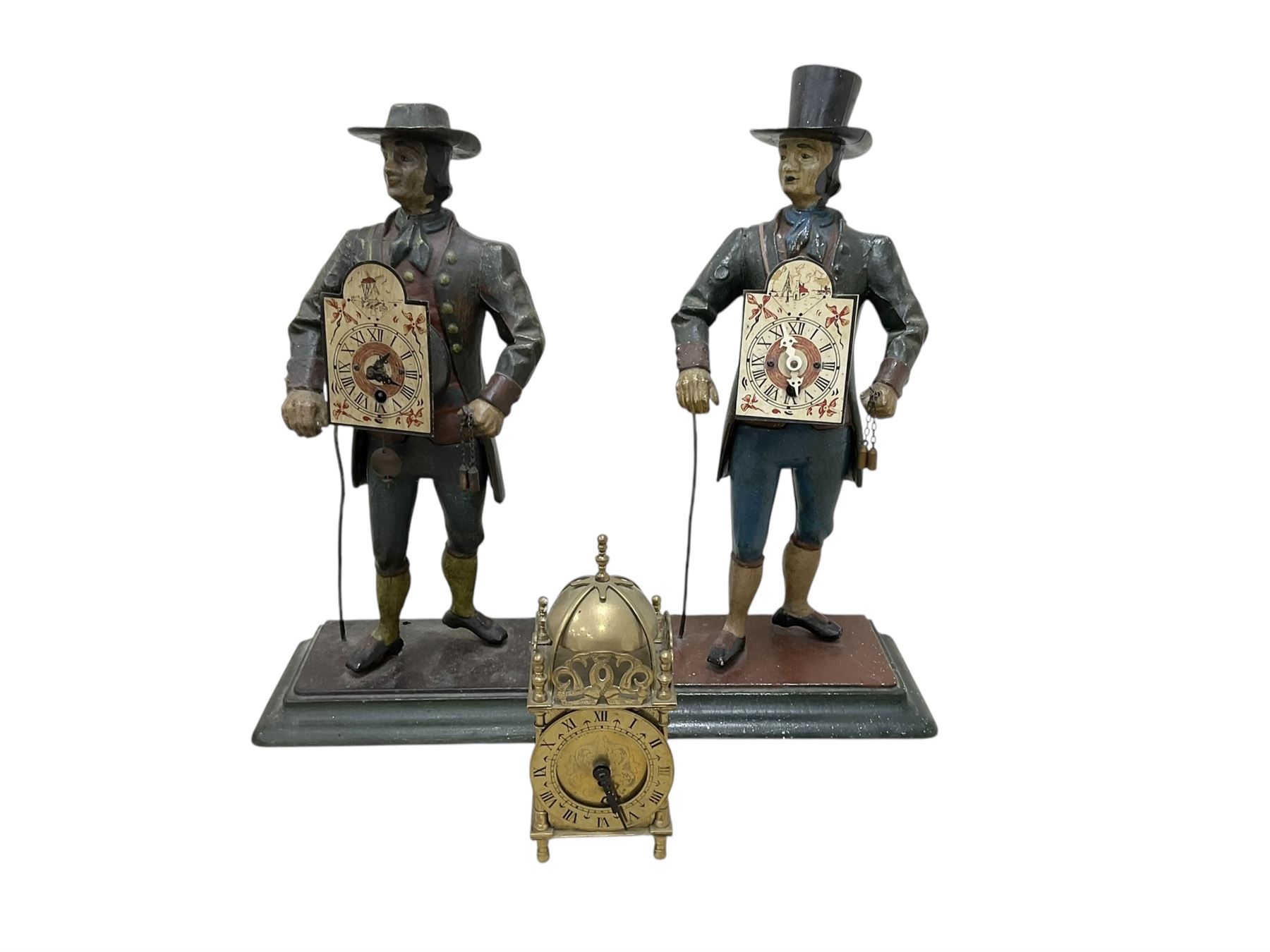 Two 29th century reproduction German traveling clockmaker figures and a small battery operated miniature lantern clock