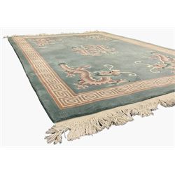 Chinese jade ground woollen rug decorated with dragons 