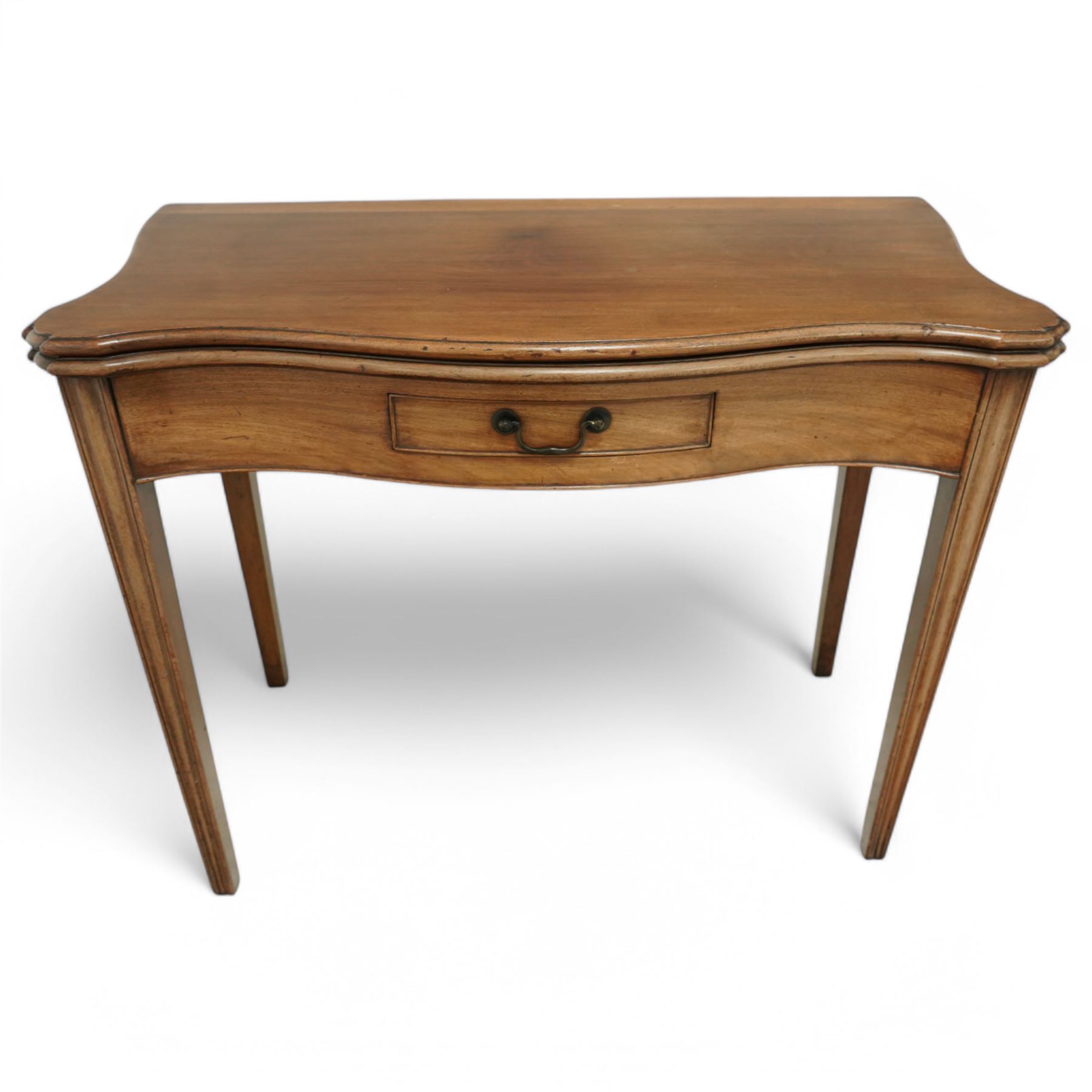 Georgian mahogany fold-over serpentine tea table, shaped rectangular top with drop leaves, fitted single drawer with brass handle, on squared tapering supports

Extended depth 90cm