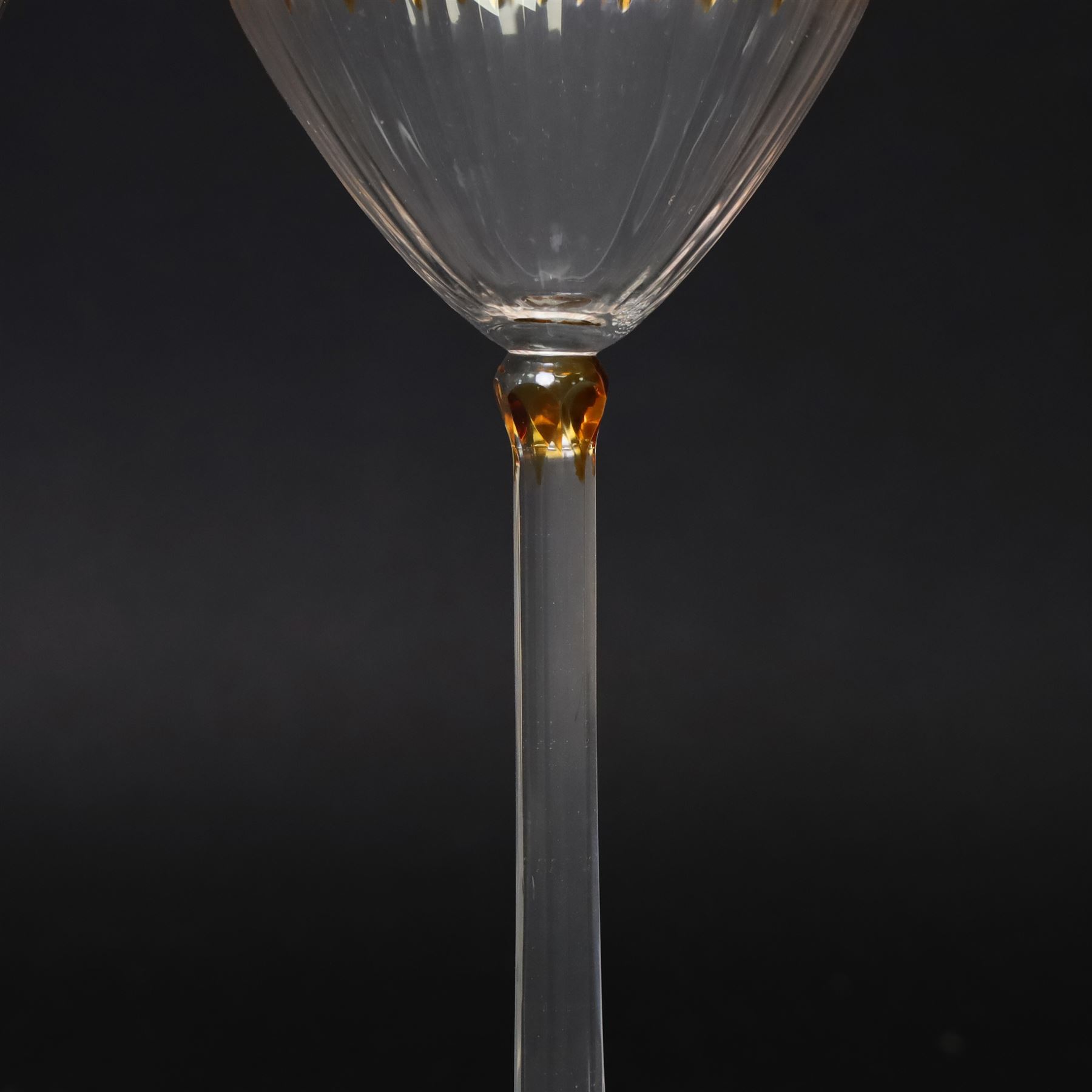 Otto Prutscher (1880-1949) - pair of early 20th century crystal wine glasses with citrine coloured ovals to the bowl and yellow stained at the top of the stem on a trumpet shape foot H21cm Notes: The glasses were probably made at the Meyr's Neffe glassworks, Adolf, Bohemia for the retailer E Bakalowits & Sohne, Vienna circa 1909