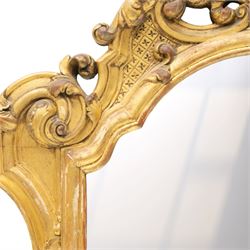 19th century Italian Baroque Revival carved giltwood and gesso wall mirror, the large acanthus leaf pediment flanked by C-scrolls and further acanthi motifs, enclosing a shaped arch plate with moulded slip, flanked by down-scrolls of acanthi with emerging flowering branches, on a stepped base