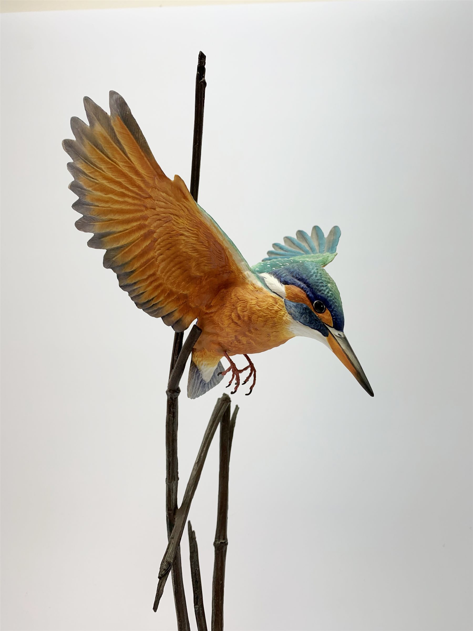 David Fryer Studios for Royal Worcester, a limited edition bronze and porcelain model of a kingfisher in flight, supported by bronze rushes, upon a clear base, signed D Fryer, and numbered 206/750, H48cm. 
