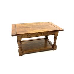 Traditional oak two tier coffee table, turned supports united by under tier 