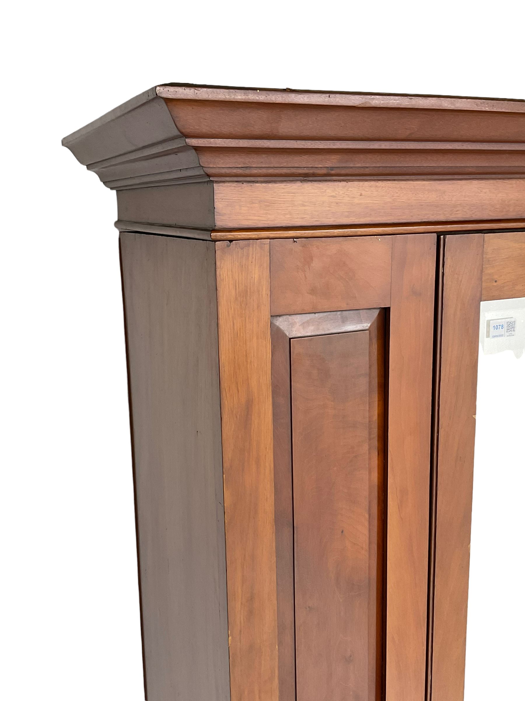 Edwardian walnut single wardrobe, projecting cornice over panelled front and bevelled mirror glazed door, single drawer to base