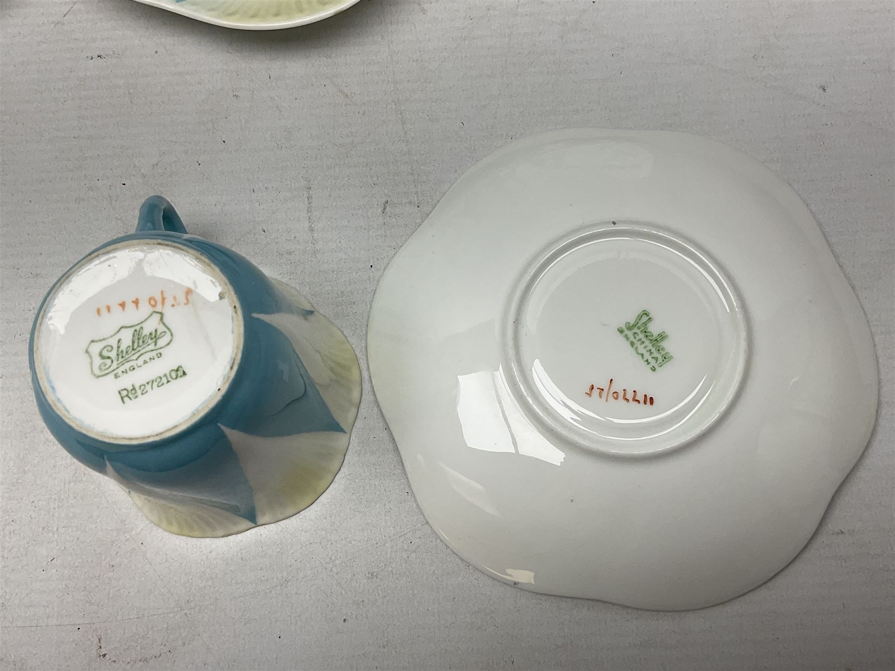 Shelley Dainty pattern tea wares, of lobed form with blue star decoration on merging white and yellow ground, comprising five teacups, five saucers, six tea plates, milk jug and cake plate, all with printed green mark beneath, some with painted pattern no 11770