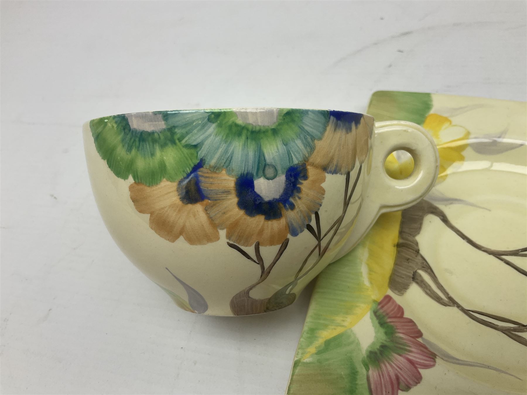 Clarice Cliff Biarritz for Royal Staffordshire/Wilkinson Ltd, teacup, saucer and side plate, in Viscaria pattern, the plate and saucer of rectangular form, each with printed mark beneath