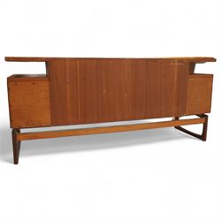R Bennett for G Plan - mid-20th century teak 'Quadrille' desk or dressing table,  shaped platform rectangular top above rectilinear open base above four drawers with sculpted handles, on rectangular frame supports 