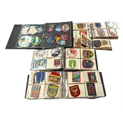 Large collection of souvenir cloth badges and vinyl stickers, mostly contained within albums