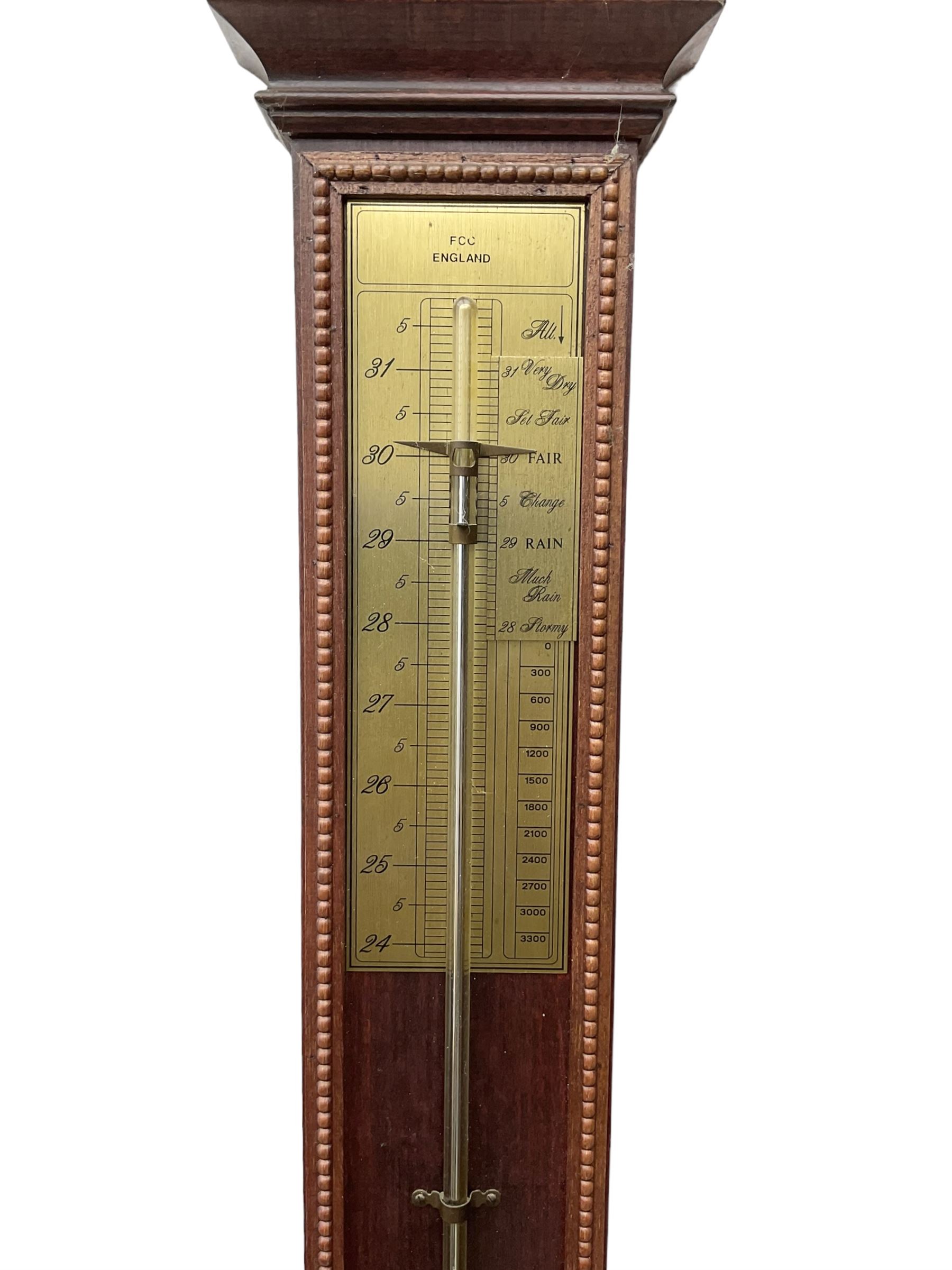 20th century - Replica mercury wall mounted stick barometer, fully glazed case with a gilt register measuring air pressure in inches, adjustable vernier and recording pointer, with a conforming thermometer  recording the temperature in degrees Fahrenheit and Celsius.  