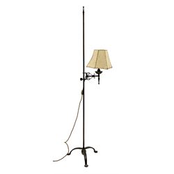Cast and wrought metal standard lamp, single adjustable branch with a vellum shade, plain rod column with finial on tripod base