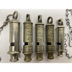 Three Hull City Police 'Metropolitan' whistles by J. Hudson 13 Barr Street Birminham, each with impressed collar number; another 'Metropolitan' police whistle with chain; and an ARP whistle by Hudson & Co with chain (5)