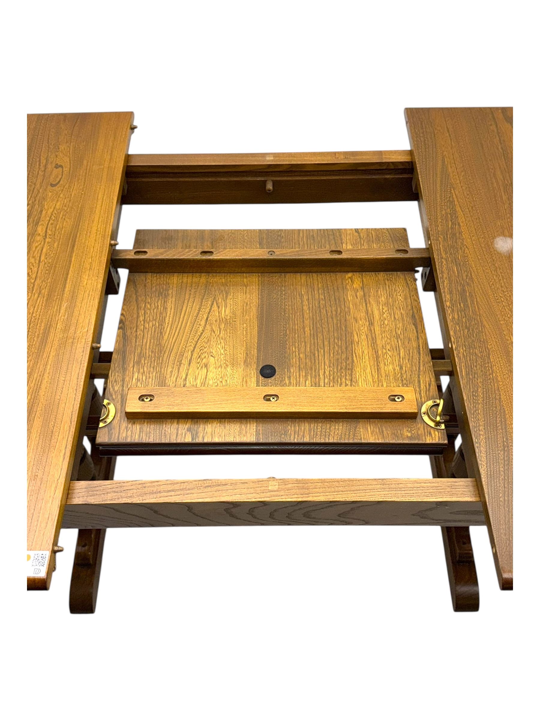 Ercol - late 20th century oak refectory dining table, rectangular top with rounded corners and central extending leaf, raised on turned baluster supports united by a stretcher (Extended 200cm)