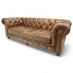 Timothy Oulton, Halo - late 20th century brown leather Chesterfield settee, the upholstered frame with deep buttoning to back and arms, large scroll terminals with brass studwork, twin seat cushions, raised on castored legs