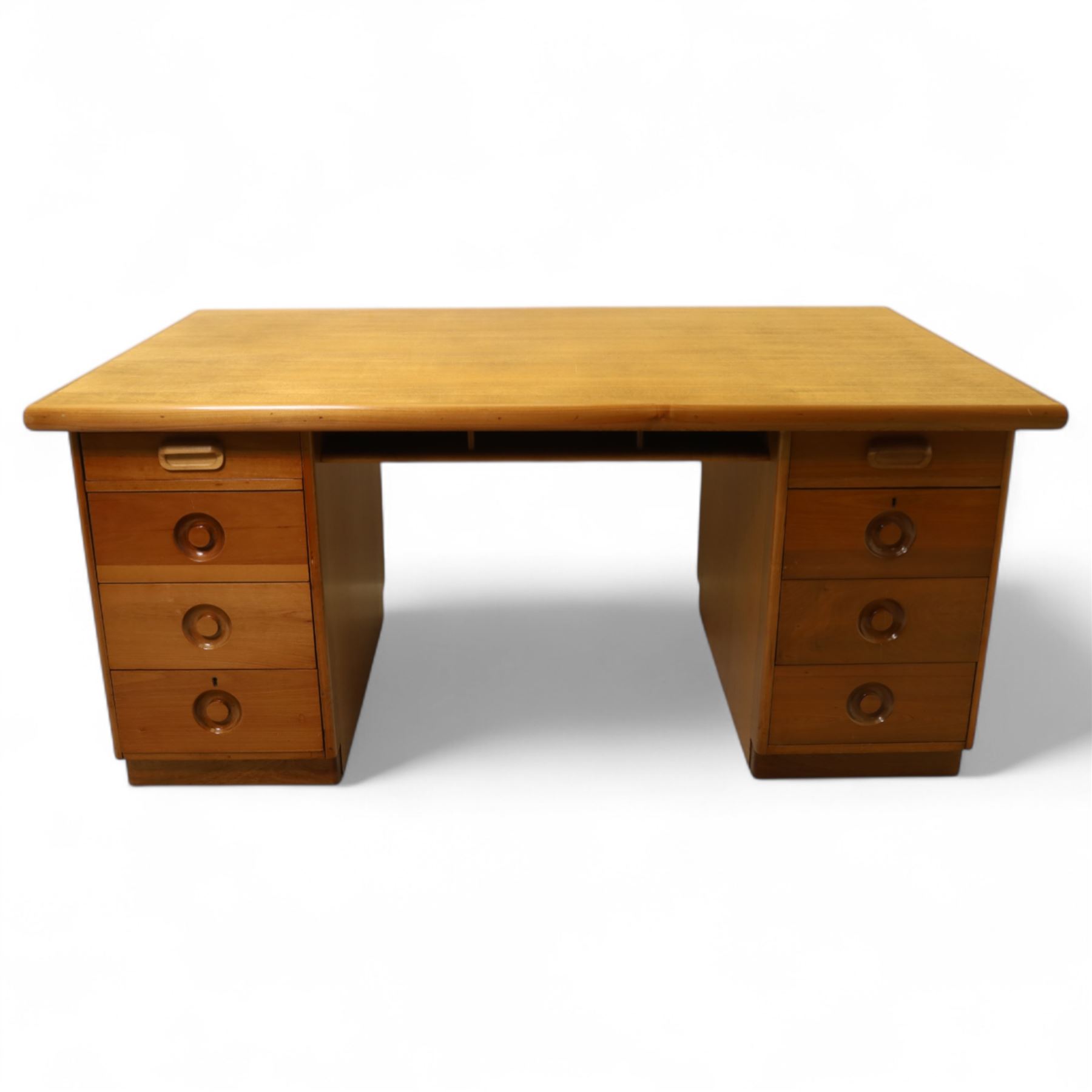 Mid 20th century teak twin pedestal partners desk, rectangular top with rounded corners with integral frieze storage shelf, above  pedestals each fitted with three drawers, recessed circular pull handles, cupboard doors fitted to the opposing side on concealed plinth bases
