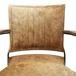 Mid century style cocktail cowhide chair, upholstered in tan cowhide, rectangular back and curved seat with stitched panels and laced borders, shaped wooden armrests on curved black metal supports 