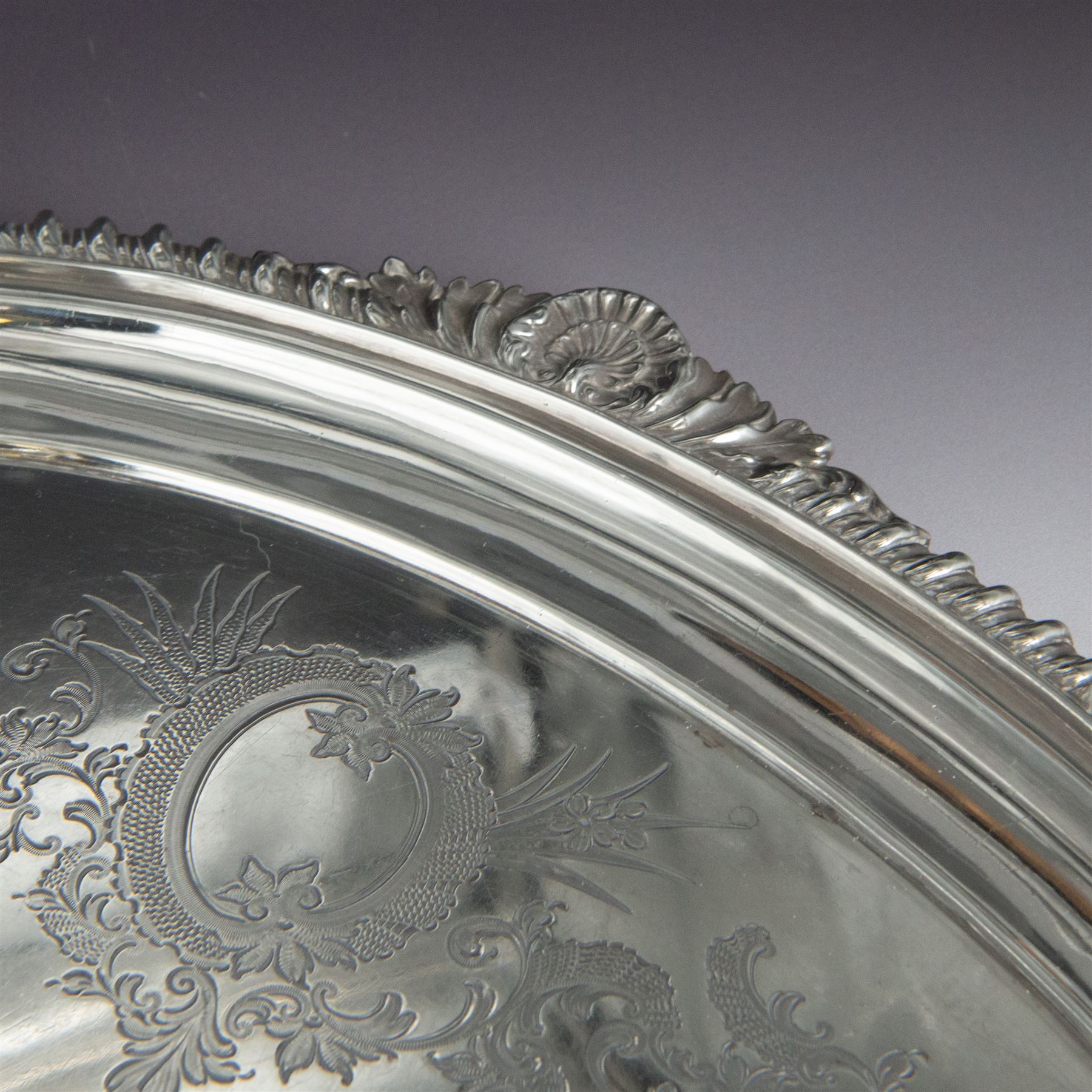 Victorian silver twin handled tray, of oval form, engraved with floral and foliate swags with vacant cartouche to centre, with oblique gadrooned rim, palmette details and foliate decoration to handles, hallmarked Atkin Brothers, Sheffield 1901, handle to handle W70cm