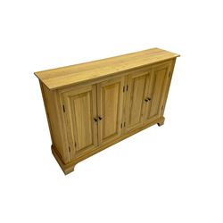 Light oak sideboard, fitted with four panelled cupboards 