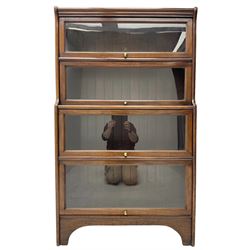 Kenric Efferson - early 20th century mahogany four-tier library bookcase, enclosed by four glazed up-and-over doors, on bracket feet