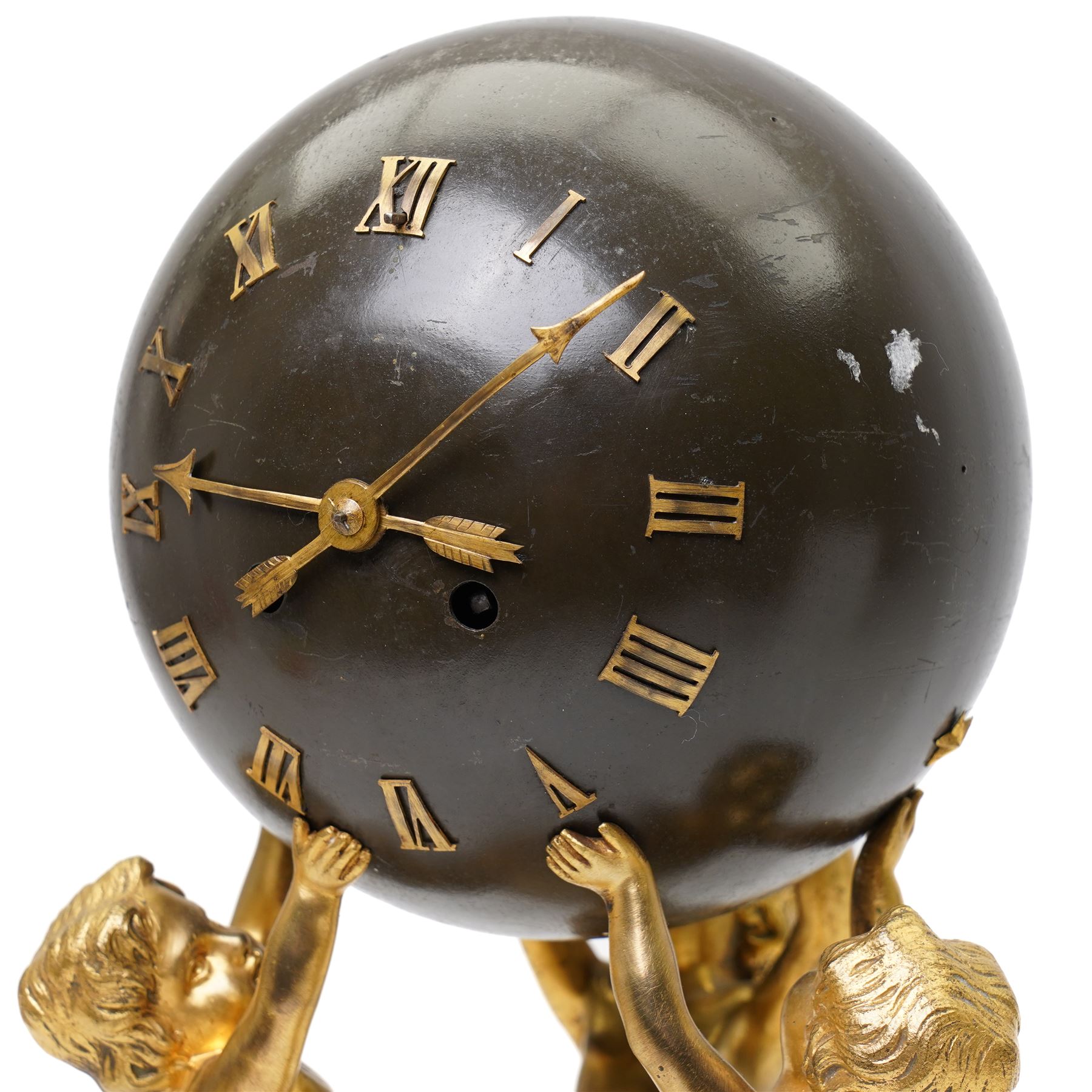 French- late 19th century 8-day globe clock, patinated globe with applied gilt Roman numerals, arrow-shaped hands and supported by three ormolu putti on a stepped columnar white marble base with a floral garland mount, twin train Parisian movement by Japy Freres with a recoil anchor escapement and countwheel strike, sounding the hours and half-hours on a bell. With pendulum.