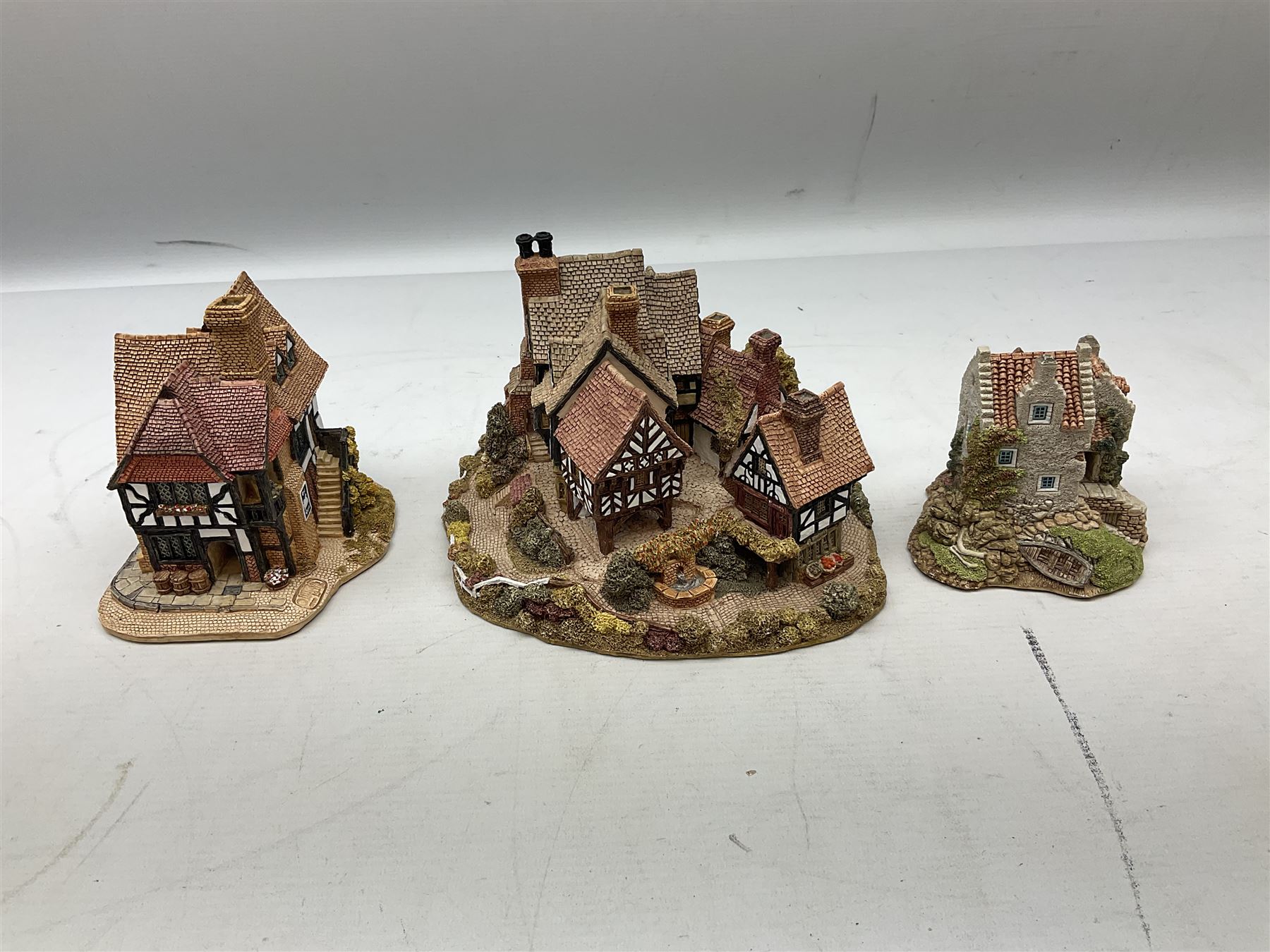 Eleven Lilliput Lane cottages from the British / English Collection, to include Tudor Court, Swan Inn, Culross House etc all boxed with deeds