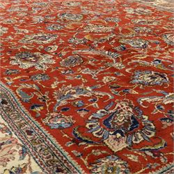 Persian Tabriz hand-knotted carpet, crimson field densely decorated with scrolling floral and foliate motifs, enclosed by a broad cream principal border with repeating floral medallions and multiple guard stripes