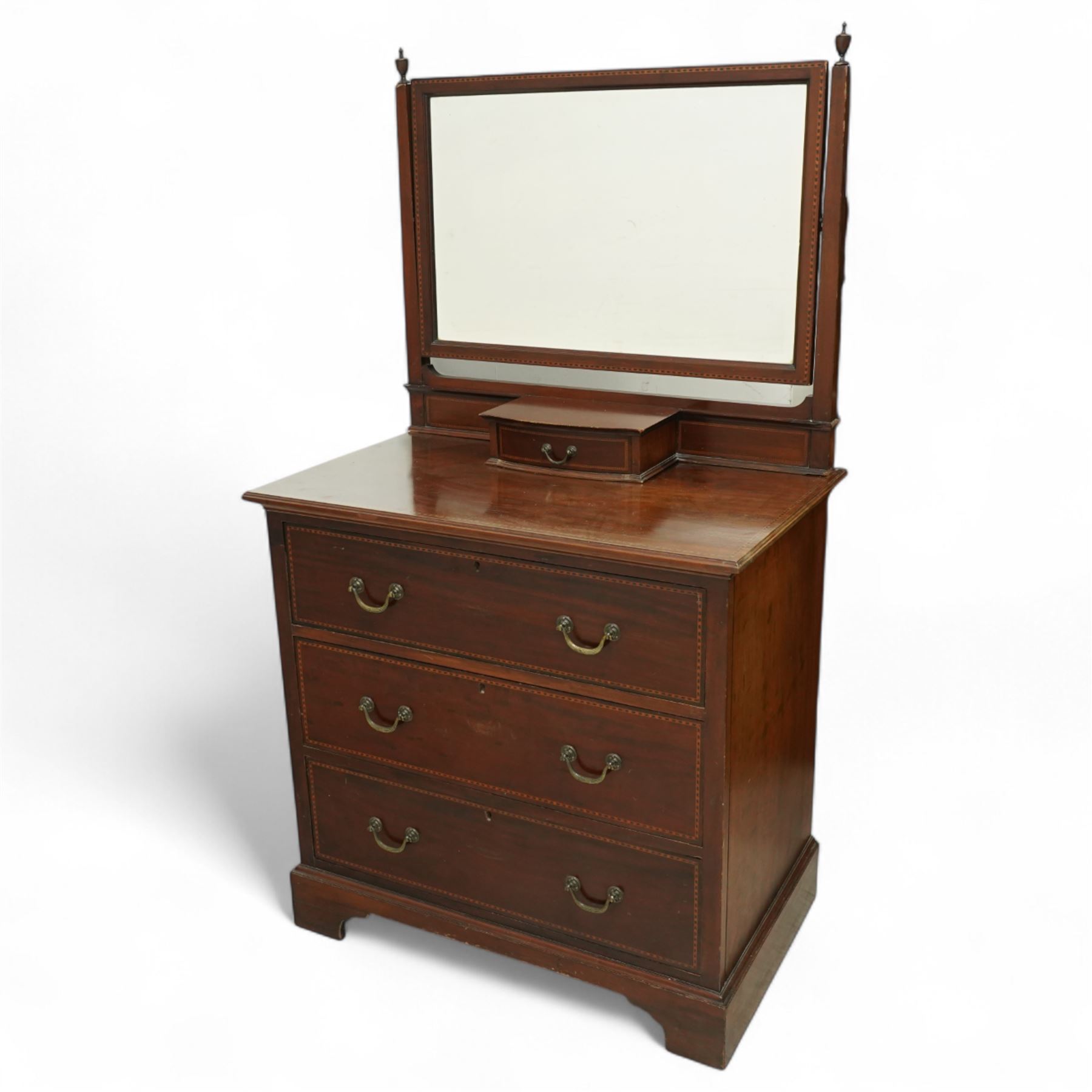 Edwardian mahogany herring-bone inlaid dressing chest, with swivel bevelled dressing mirror, supports with finials, and trinket drawer above chest with three graduated drawers on bracket feet