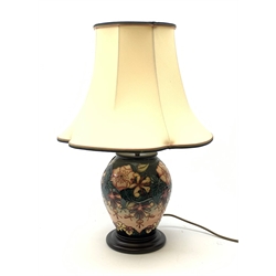 A Moorcroft Oberon pattern lamp, designed by Rachel Bishop, of baluster form and raised upon a circular stepped base, with cream fabric shade, overall H57cm.