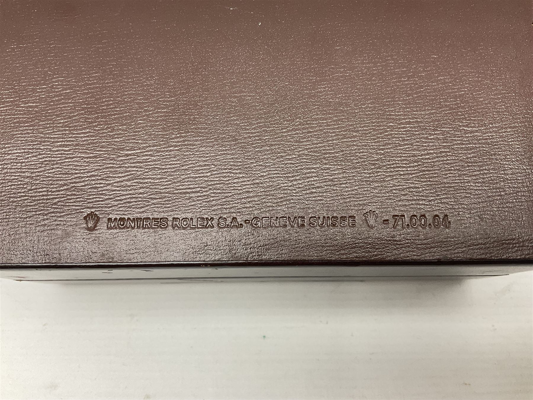Rolex brown leather box, with decorative buckle to cover, opening to reveal wooden veneer interior, the inside lid stamped in gilded lettering 'Creation Genève Rolex', stamped beneath 'Montes Rolex S.A. Geneve Swiss 71.00.04, H8cm