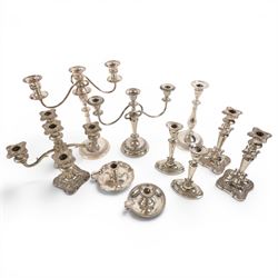 Silver plate two branch candelabra with grape vine decoration to the base, together with a matching pair of candle sticks and other candlesticks  