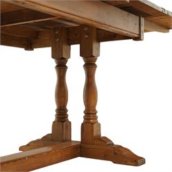 Late 20th century light oak extending refectory table, in the manner of Titchmarsh & Goodwin, rectangular plank top with cleated ends and two draw leaves extending to 260cm, supported on turned end supports united by a stretcher, raised on block feet