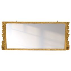 19th century George III style giltwood overmantel mirror, the rectangular bevelled plate within a moulded frame decorated with acanthus leaf and floral scroll carving to the corners, and sides flanked by two girandole sockets 