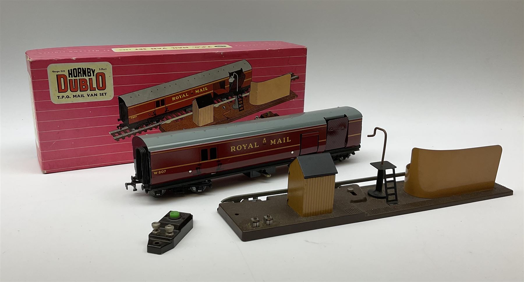 Hornby Dublo - 5080 Signal Cabin with pack of Station Names; two D1 Footbridges, one with instructions; and two 2460 Plastic Level Crossings suitable for two-rail system; 2400 T.P.O. Mail Van Set for two-rail system all boxed; together with three plastic brick effect tunnel mouths for double track layout (9)