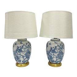 Pair of Chinese table lamps of baluster form, each decorated with landscape scene, raised upon gilt circular base, including shade H63cm