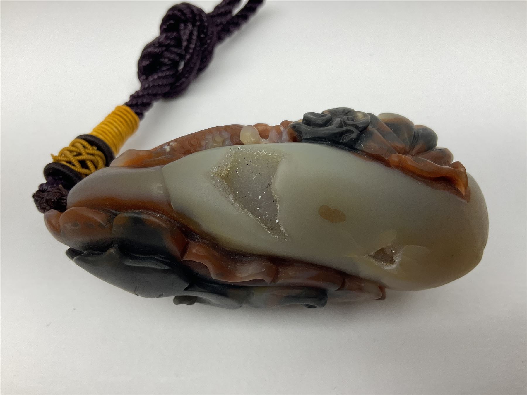 Chinese hardstone carving of a fish amongst coral, with platted rope handle, together with other hardstone and soft stone carvings  