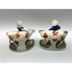 Pair of Victorian Staffordshire Pottery Figures, modelled as a milkmaid and farmer with cows, on naturalistic modelled oval bases H21.5cm.