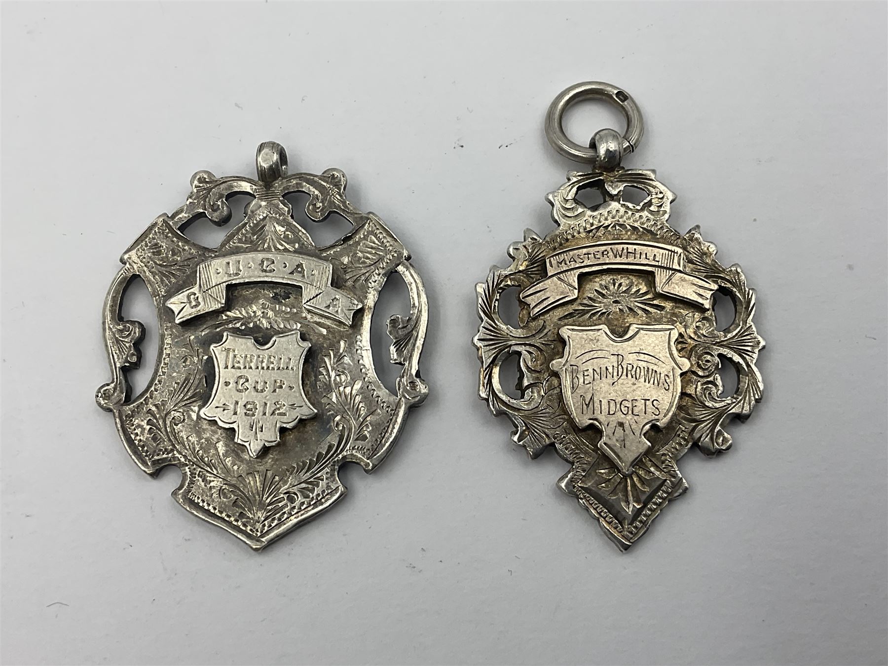 Seven Edwardian and later silver cartouche fobs, to include five gold faced examples and three double sided examples, all hallmarked with various dates and makers
