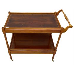 Yew wood drinks trolley, rectangular form with leather inset slide and turned handle, the undertier fitted with drawer, turned supports and brass castors